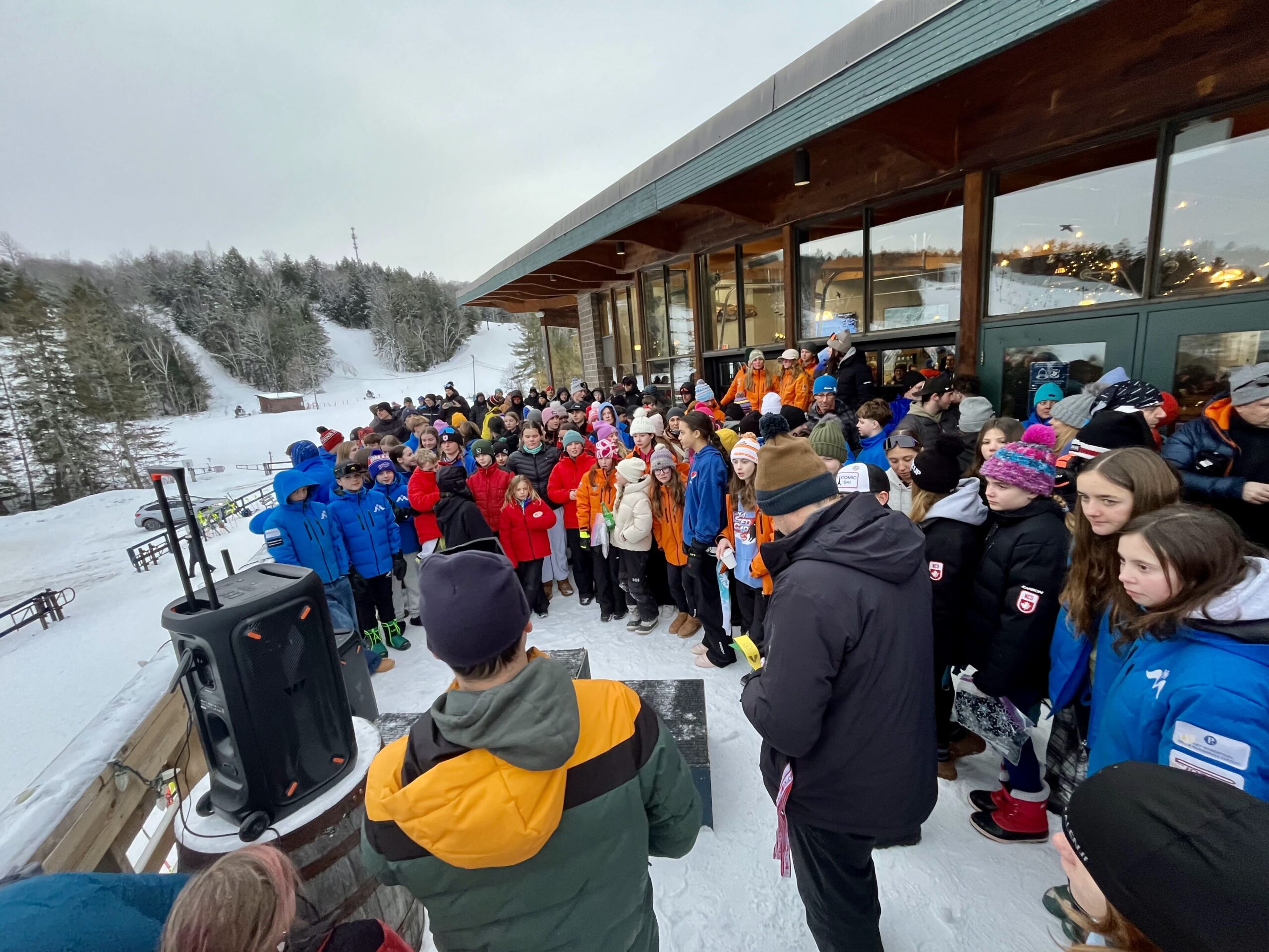 Families relaxing at the sunny Vorlage lodge between sessions